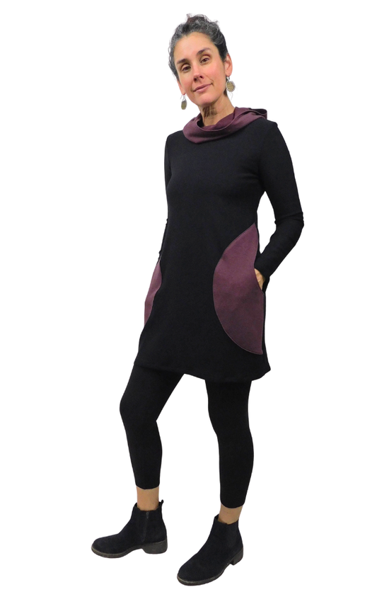 Woman wearing a black and purple tunic with a white background