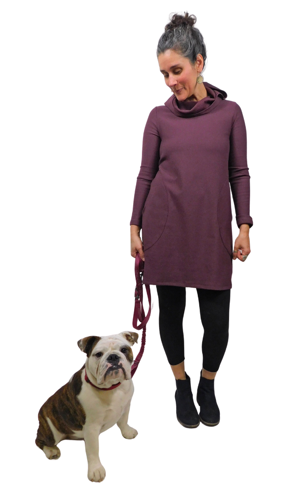 Woman wearing long sleeve tunic & tights with bulldog on leash