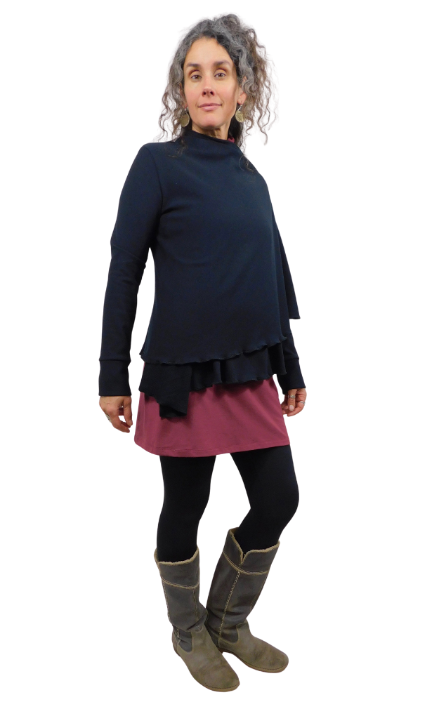 Woman wearing a black top and wine coloured skirt with gray boots on a white background