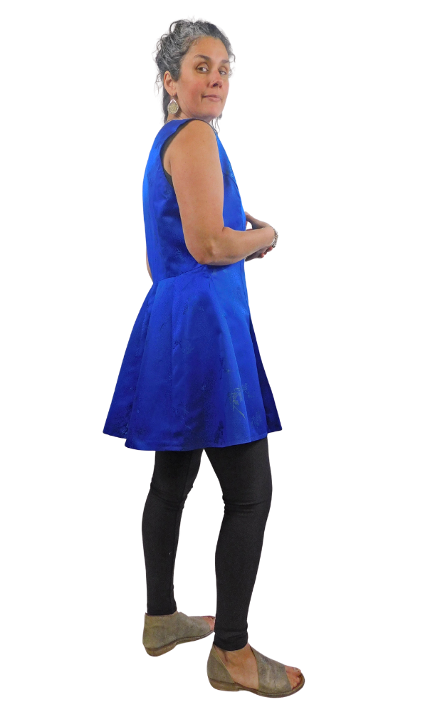 Woman wearing a blue sleeveless top and black leggings on a white background