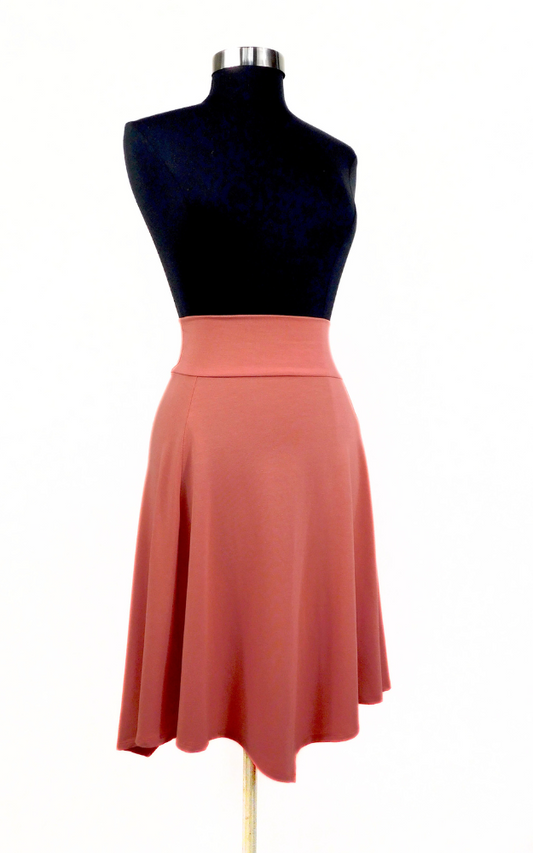 Peach coloured flared knee length skirt  worn on black dress dummy