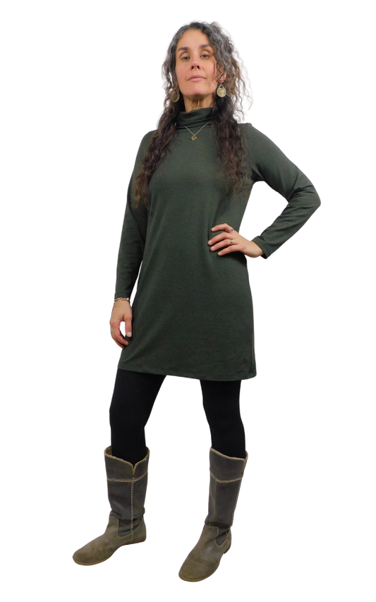 Woman wearing a green dress and boots on a white background