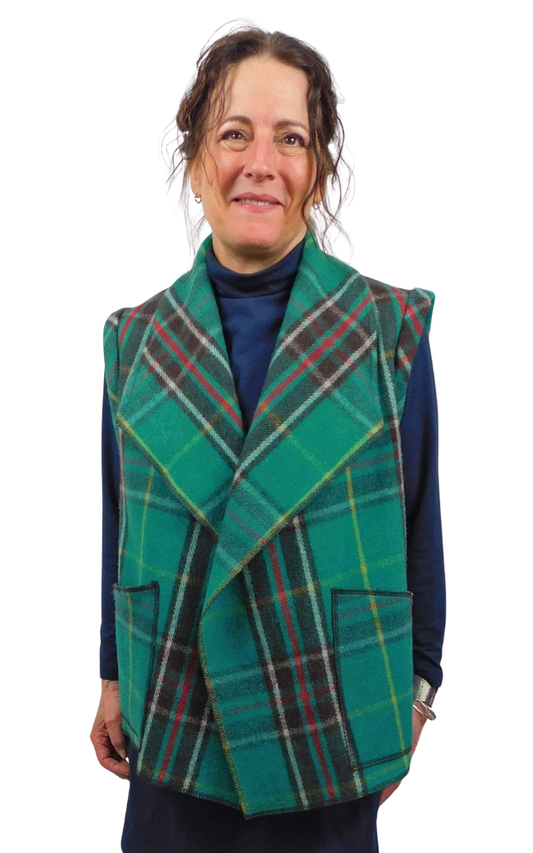 Woman wearing a green tartan vest on a white background