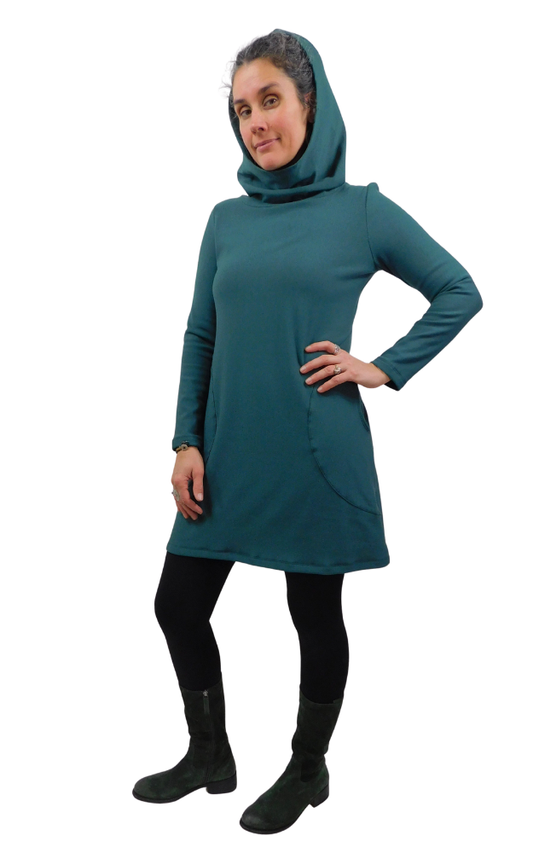 Person wearing a pine green dress with a hood on a white background