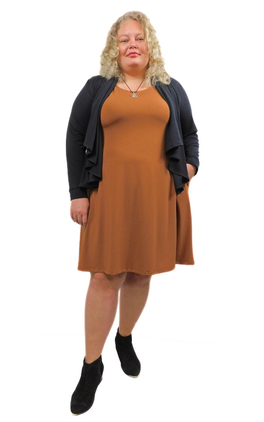 Woman wearing a brown dress with a black cardigan on a white background