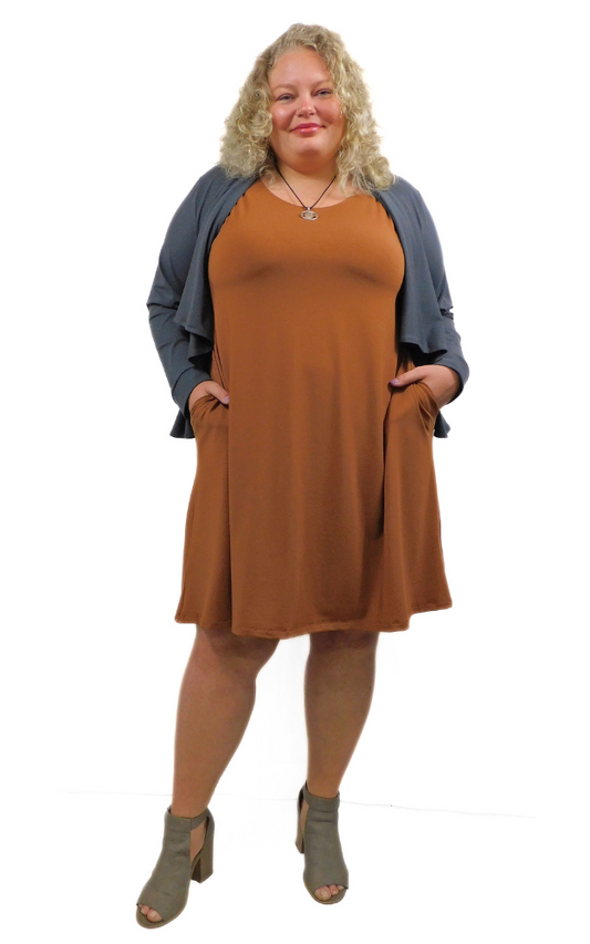 Woman wearing a brown dress with a gray cardigan on a white background