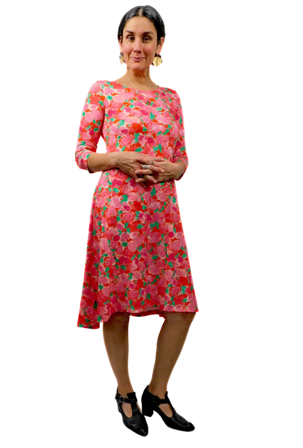 Woman wearing a pink floral dress on a white background