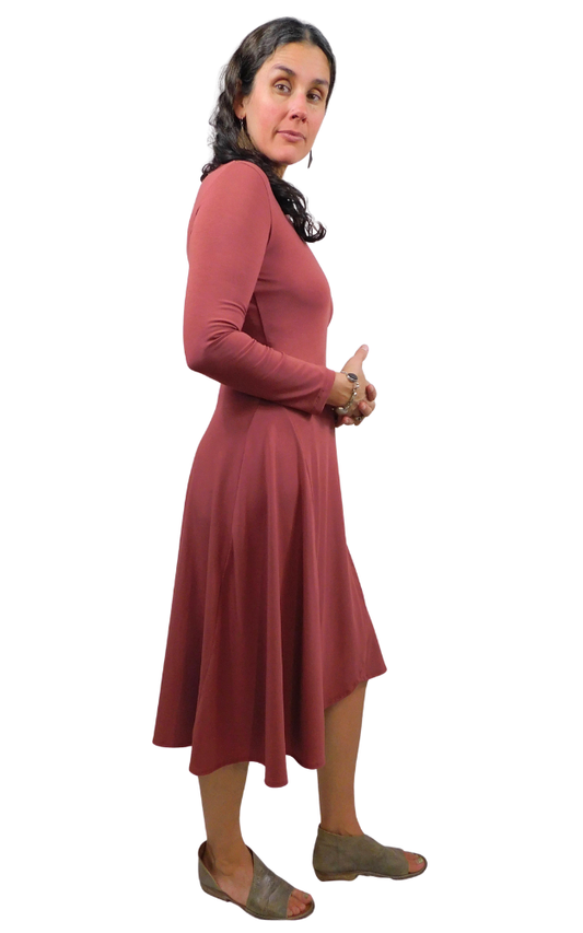 Woman wearing a wine coloured dress with a white background
