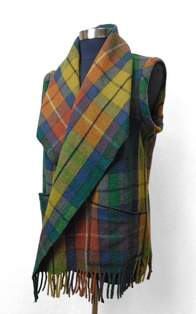 Plaid tartan vest with fringe on a mannequin against a white background