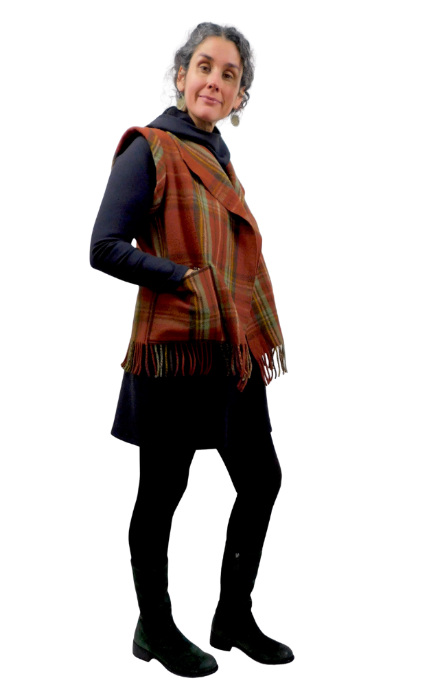 Person wearing a plaid vest over a dark outfit on a white background