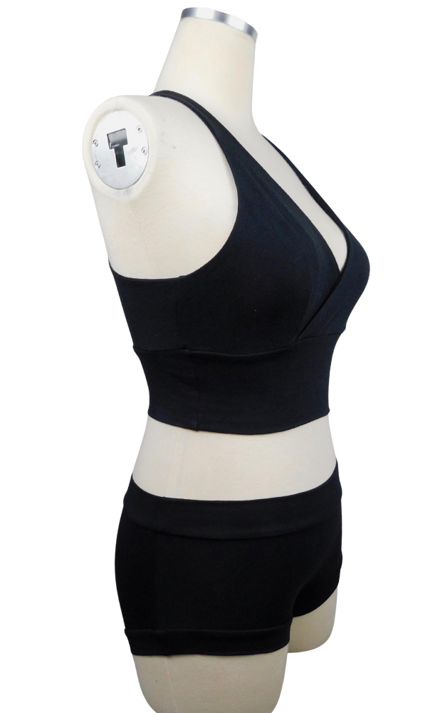 Black sports bra and shorts set on a mannequin against a white background