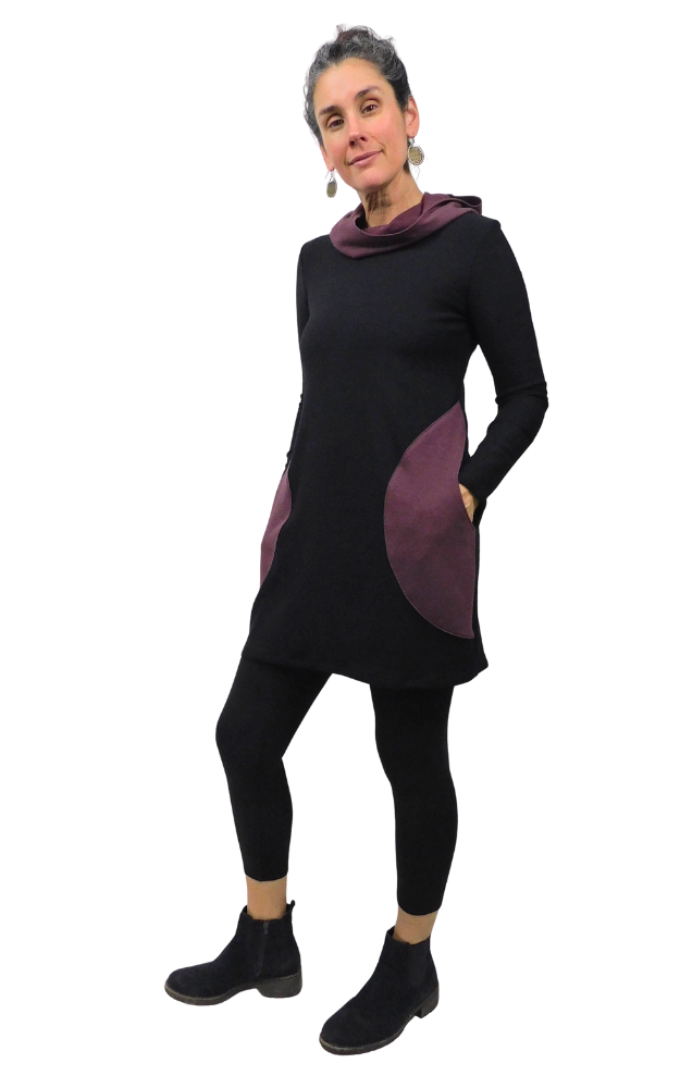 Woman wearing a black and purple tunic with a white background