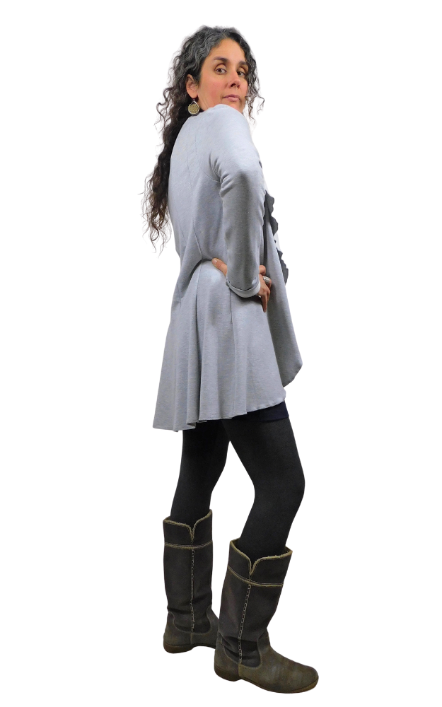 Woman wearing a gray cardigan, black tights and dark gray boots on a white background