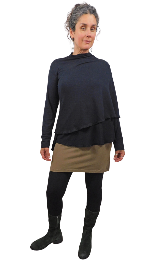 Woman wearing a black wrap top and beige skirt on a white background