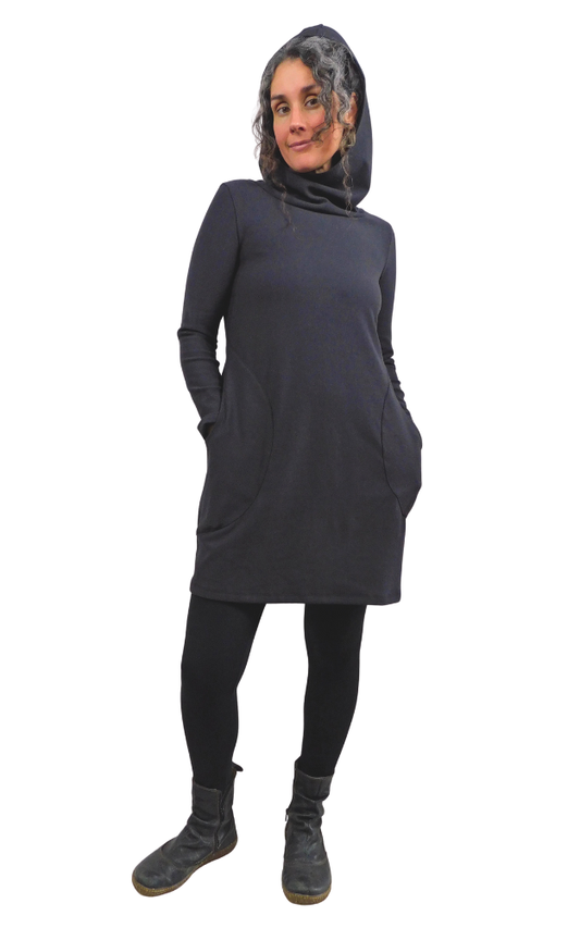 Woman wearing a long-sleeve black tunic dress with a hood on a white background