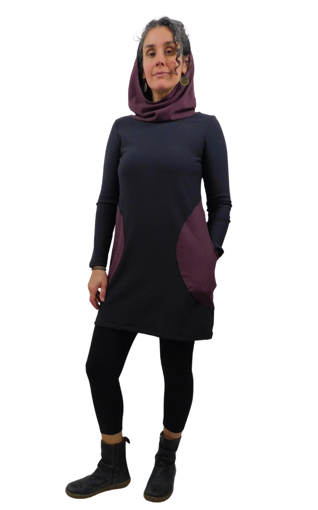 Woman wearing a black and purple tunic with a white background