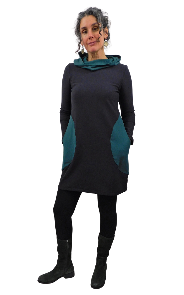 Woman wearing a black and green dress with a hood on a white background