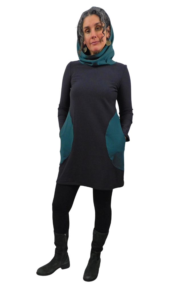 Woman wearing black tunic with green hood and pockets on a white background.