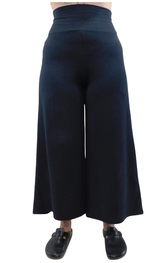 Black wide-leg pants worn by a person on a white background