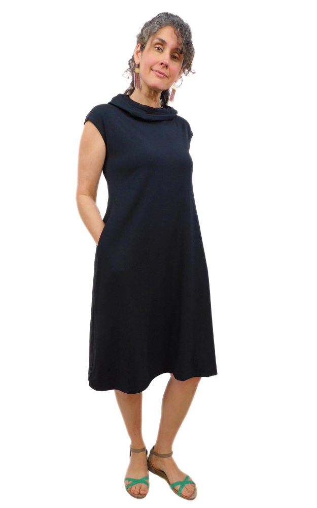 Black capped sleeve wide long tunic dress with side pockets and large hood that can drape around the neck as a cowl. Garment is made from a 
High Twist Jersey knit w/Spandex, with a lovely stretch and drape. 