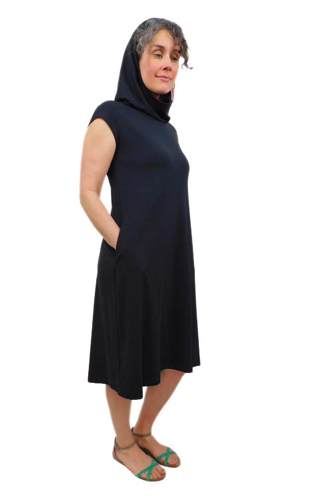 Black capped sleeve wide long tunic dress with side pockets and large hood that can drape around the neck as a cowl. Garment is made from a 
High Twist Jersey knit w/Spandex, with a lovely stretch and drape. 
