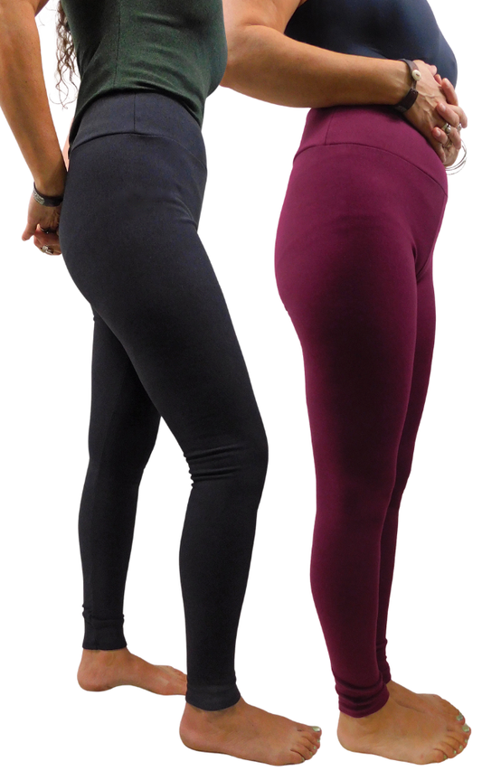 Two models shown from the waist down wearing high-waisted leggings, one in black and one in deep burgundy, standing barefoot against a white background.