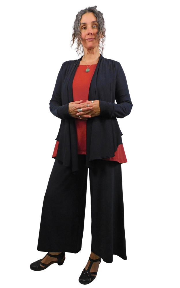 Woman wearing a black outfit with a red top on a white background