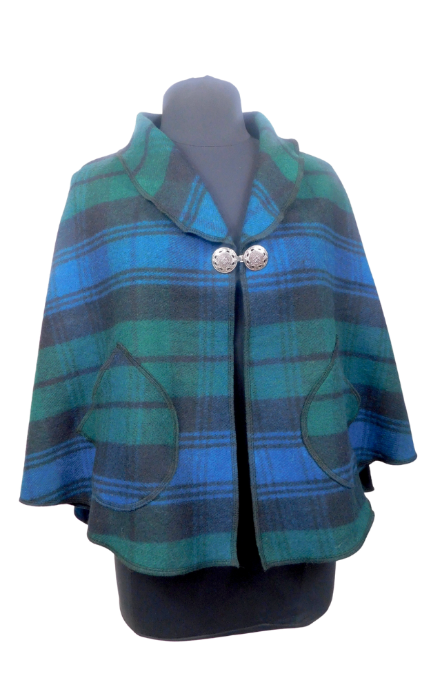 Blue and green and black tartan plaid cape on a mannequin with a white background