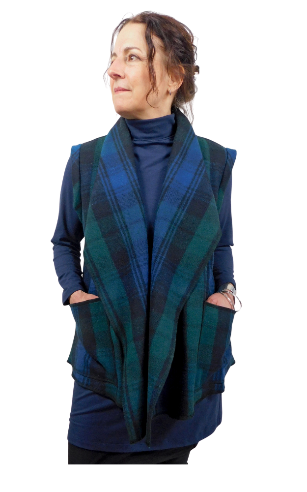 Woman wearing a blue and green tartan vest on a white background