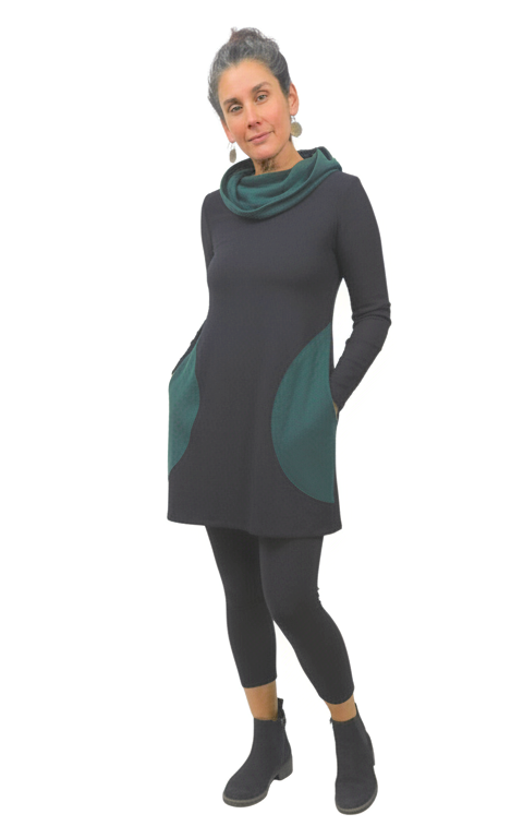 Woman wearing a dusky black dress with green accents on a white background