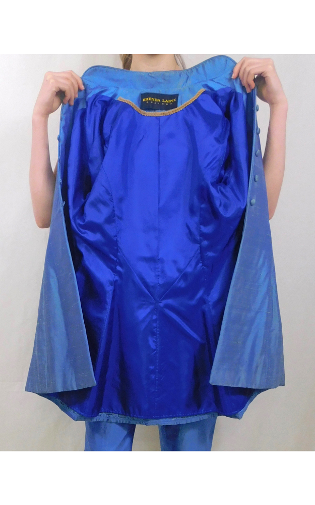 Someone holding a blue jacket open to show the inside