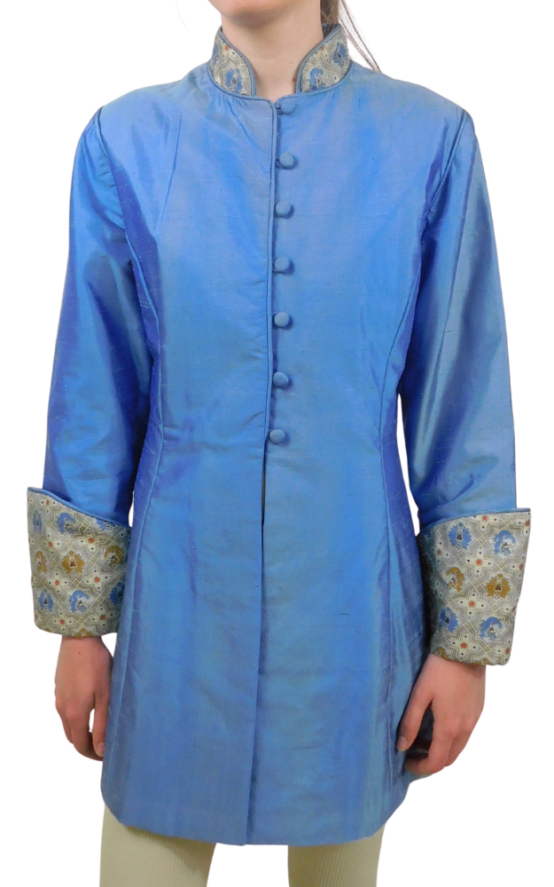 A blue jacket with with brocade collar and cuff standing against a white background