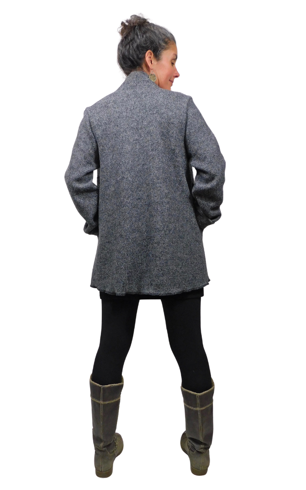 Back view of woman wearing charcoal wool coat and black tights and grey boots