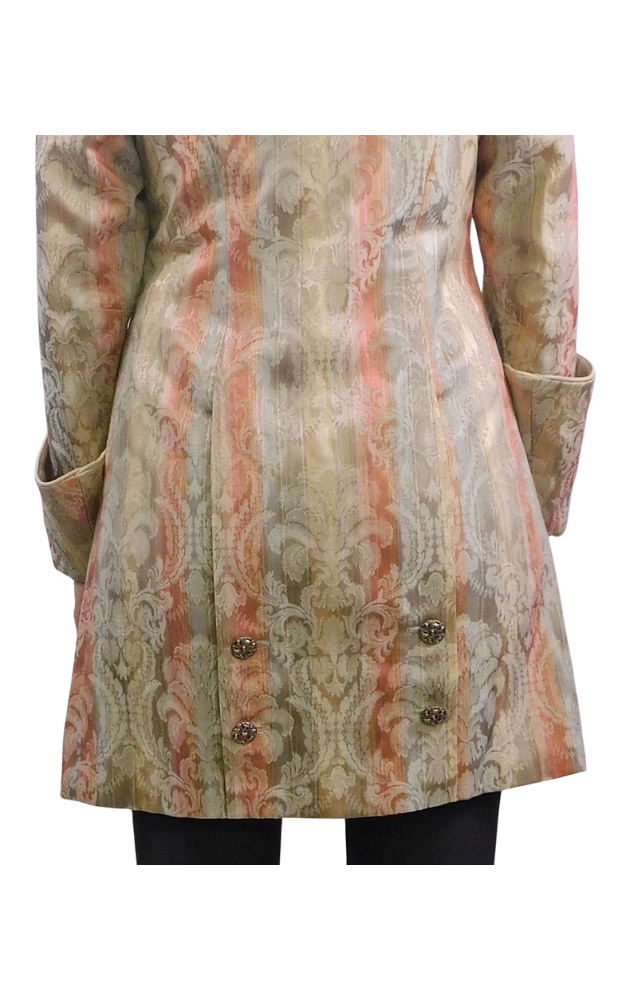 Patterned coat back detail with decorative buttons on a white background