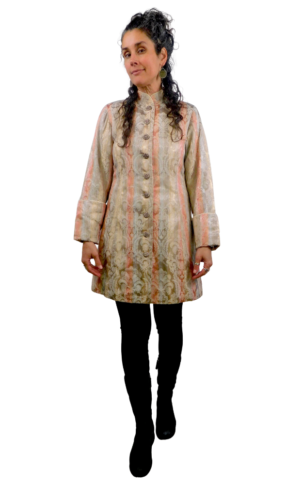 Woman wearing a patterned coat on a white background