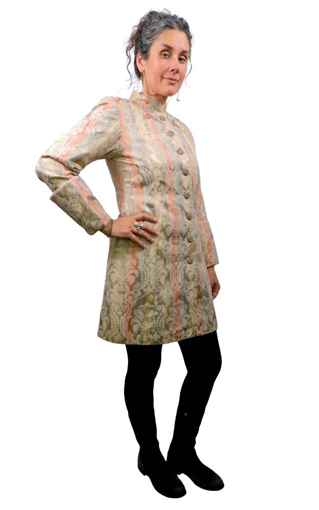 Woman wearing a patterned coat against a white background