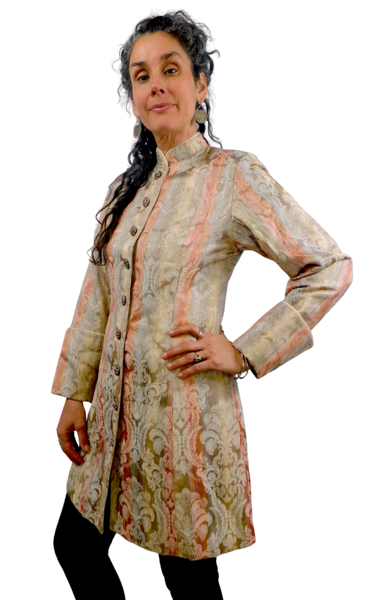 Woman wearing a patterned coat on a white background