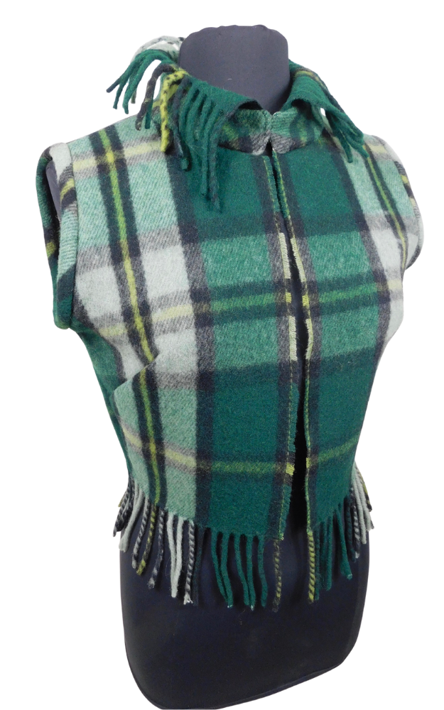 A green and white plaid fringed vest displayed on a black mannequin torso against a plain white background.