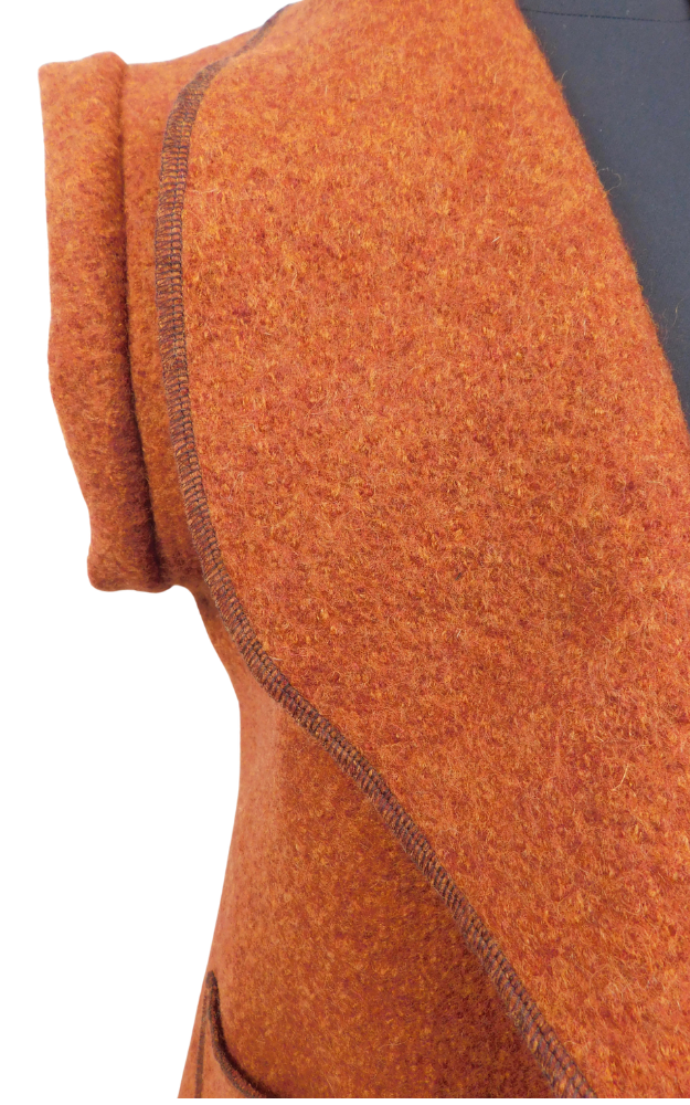 Close up of rust coloured boiled wool fabric