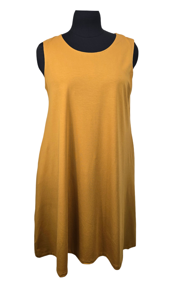 Mustard yellow sleeveless dress on a mannequin with a black top against a white background