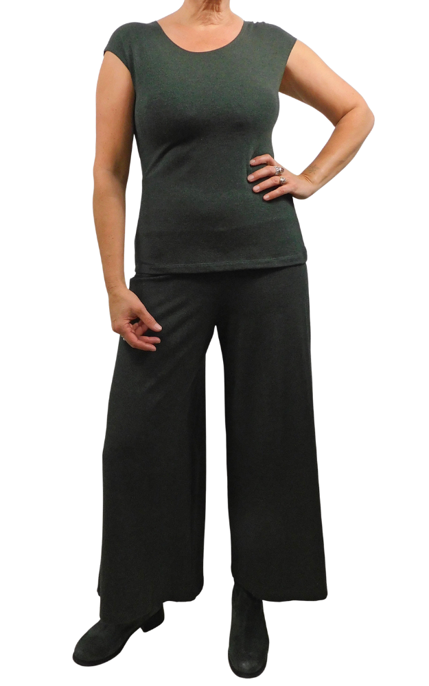 A woman modeling a dark green short-sleeve scoop-neck top and matching wide-leg pants against a plain white background.