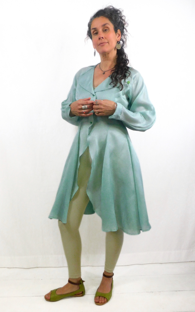 Woman wearing a light green dress with a white background