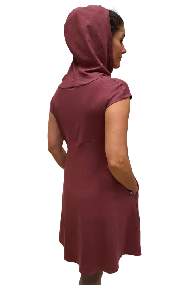 Woman wearing a burgundy dress with a hood on a white background