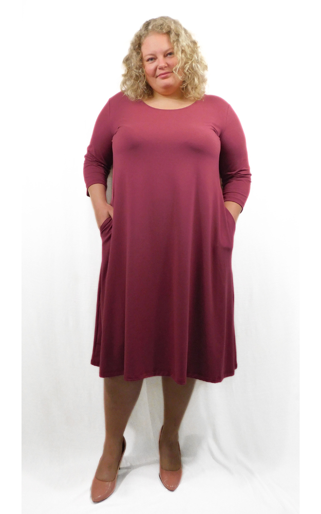 Woman wearing a burgundy dress on a white background