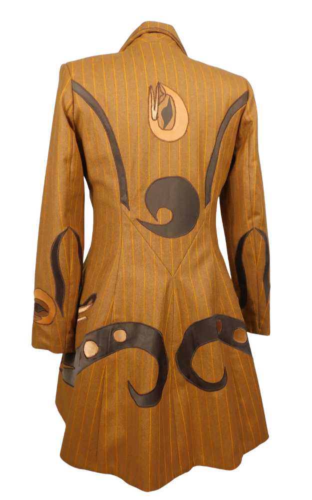 Striped golden brown coat back view with decorative native artwork patterns 