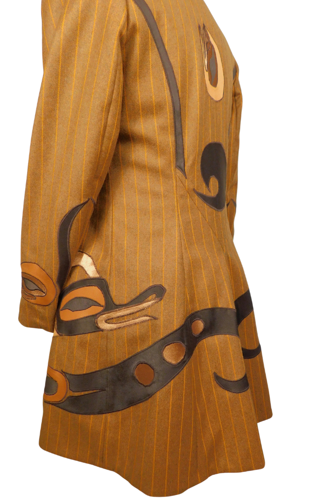 Striped golden brown coat close up of side back to show native art design on skirt and cuff 