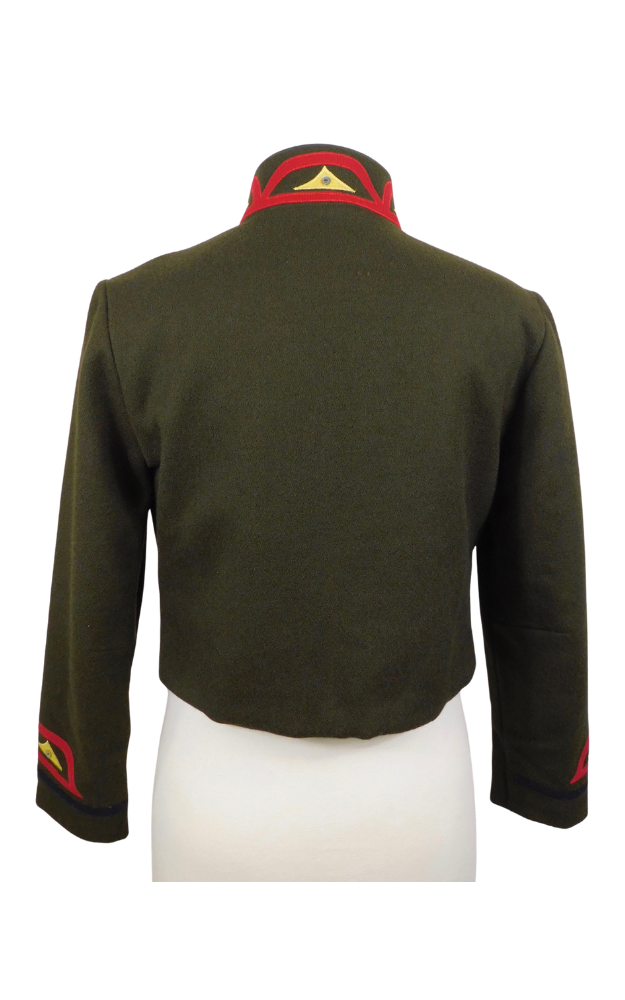 Green jacket and skirt with red and gold decorative elements on a white background