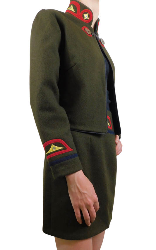 Green jacket and skirt with red and gold decorative elements on a white background