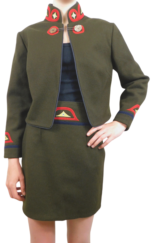 Green military-style jacket and skirt with red and blue accents on a white background