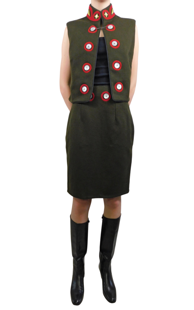 Body of woman wearing green vest and skirt with native art decorative elements